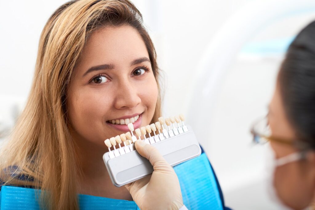 Smiling patient with a bright, healthy smile after cosmetic dental treatment